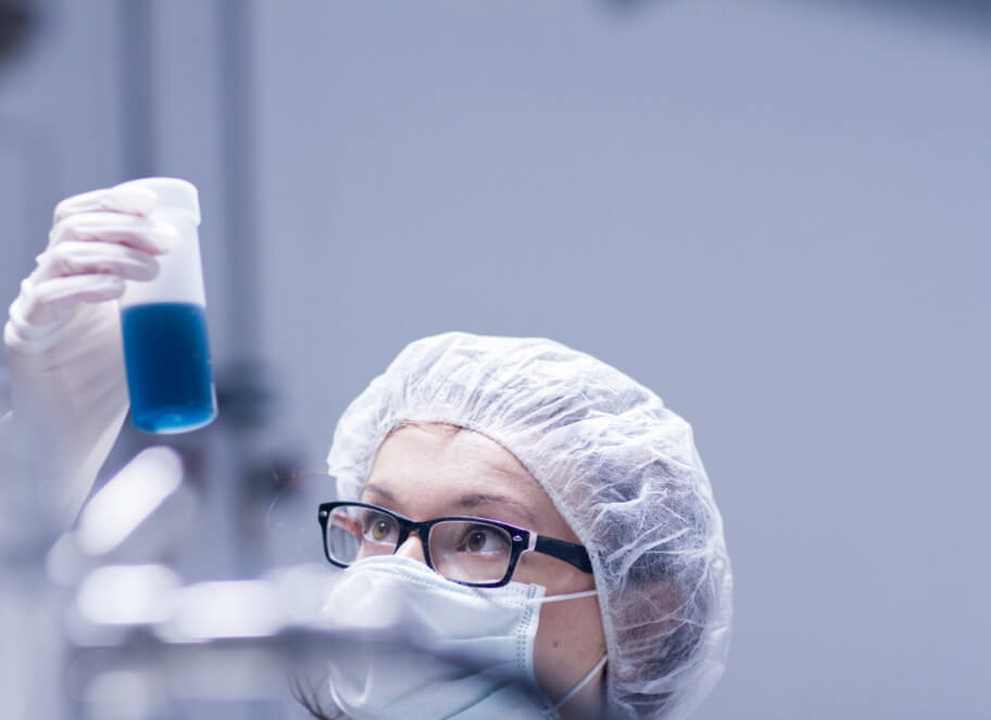 scientist holding sample up to the light