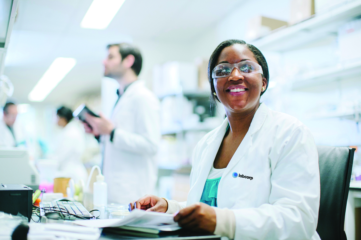 labcorp scientist sitting at a desk in a lab