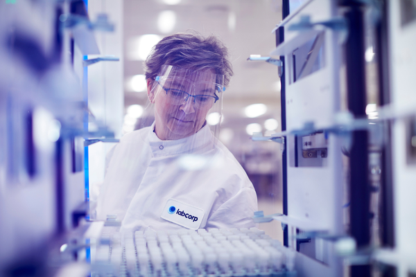 Labcorp scientist placing test tubes on a tray