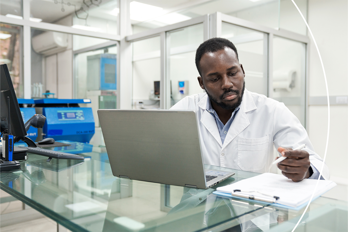 Male medical worker preparing notes at desk in laboratory